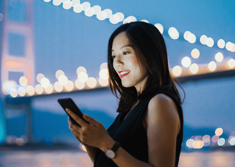 Woman looking at phone while abroad 