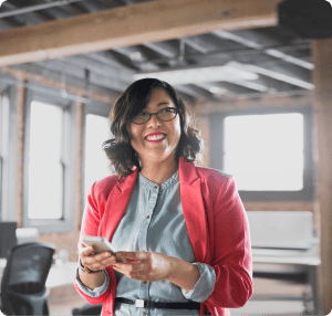 Woman typing on phone in office