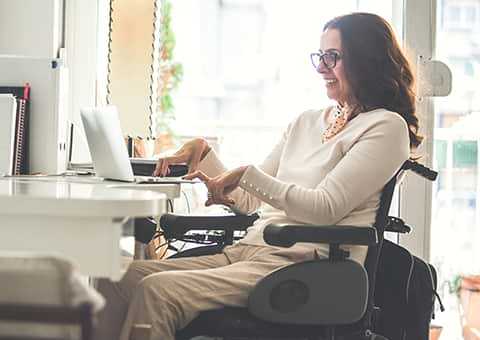 Woman in wheelchair working on laptop