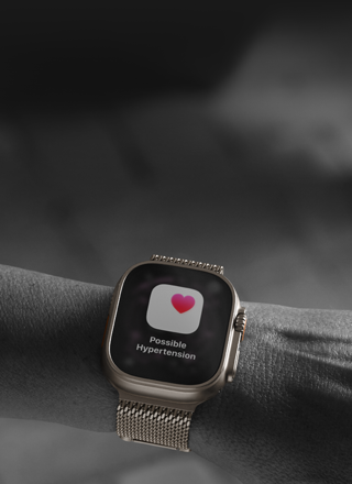Person wearing Apple Watch Ultra 3 on wrist, possible hypertension health alert screen