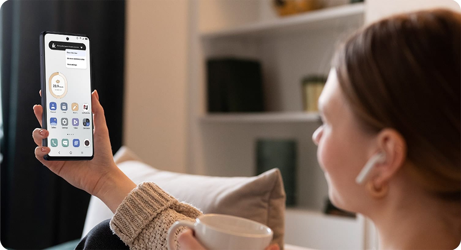 Person holding phone screen at an arms length from their face