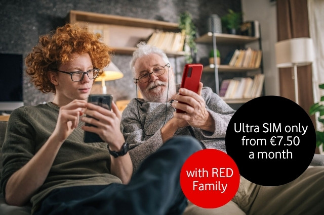 Red-haired teenage boy sitting with white-haired grandad