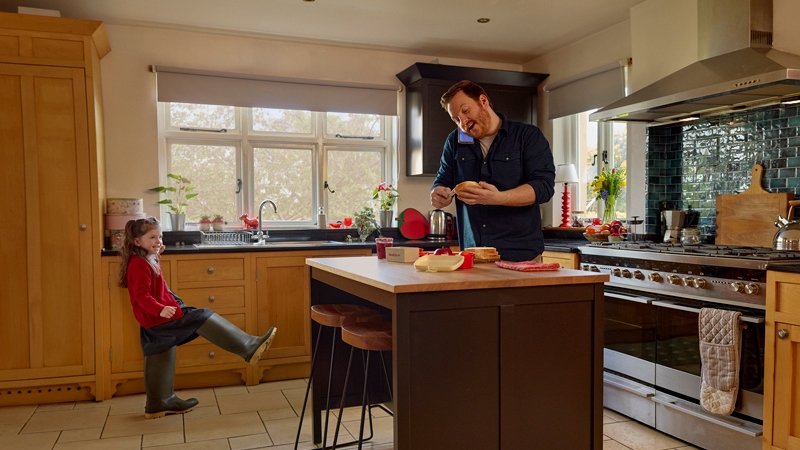 Dad and daughter enjoying in the kitchen.