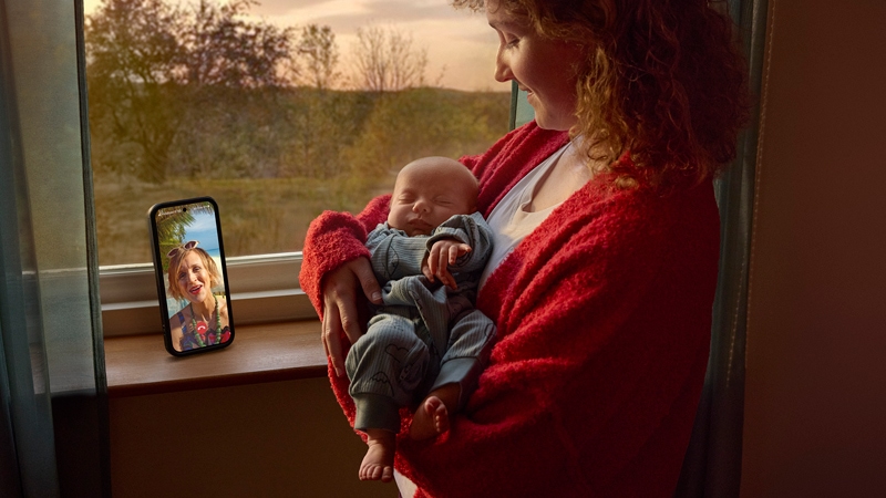 Mother holding a baby on a video call