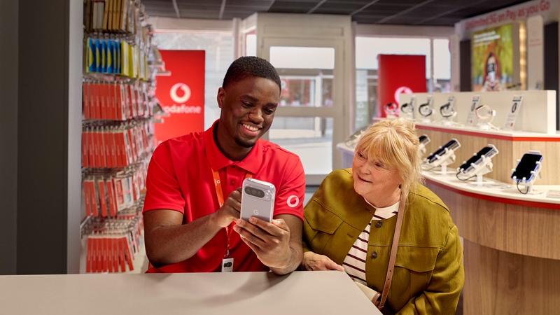 Vodafone store advisor helping a customer with a phone
