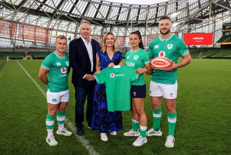 Senior team holding logos of Vodafone foundation, Childline by ISPCC, Tozi, and DCU.