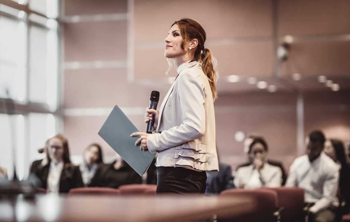 Woman speaking at office gathering Woman speaking at office gathering