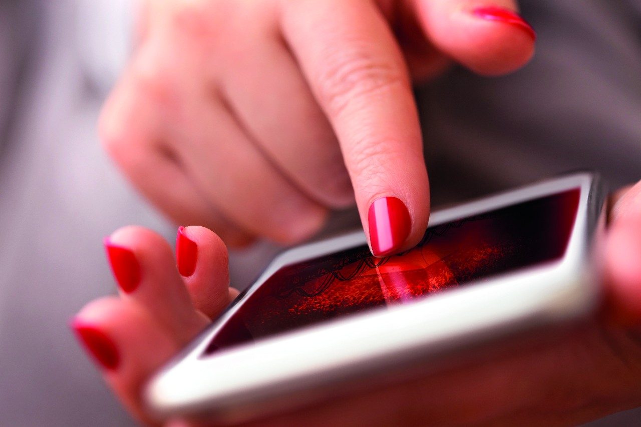 Person typing on phone screen