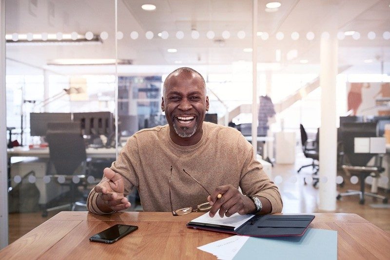 Happy man laughing at work