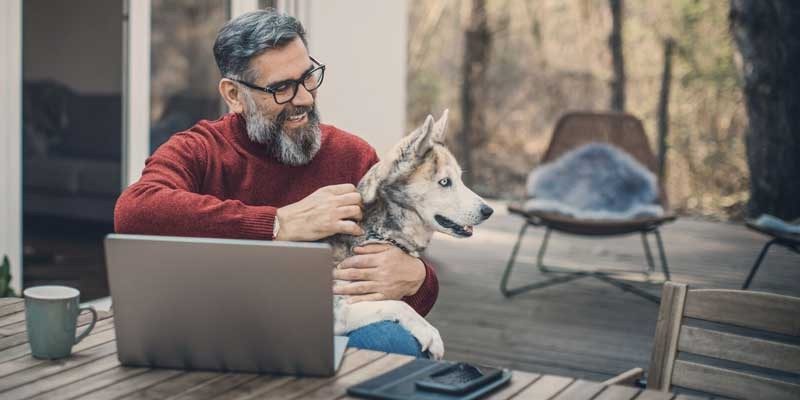 Man working at home with dog