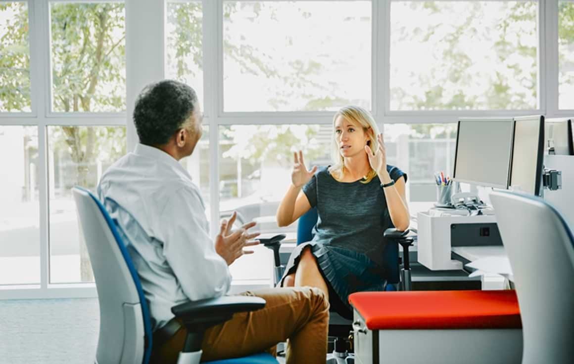 Employees talking together in office