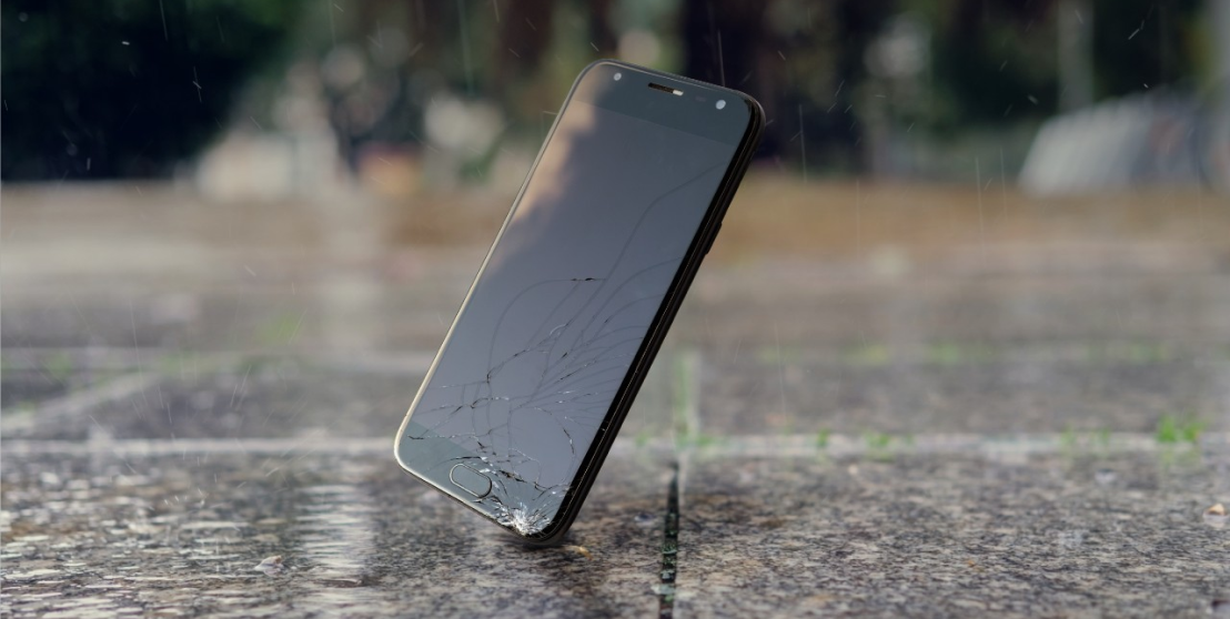 Smartphone with broken screen hitting the ground Smartphone with broken screen hitting the ground
